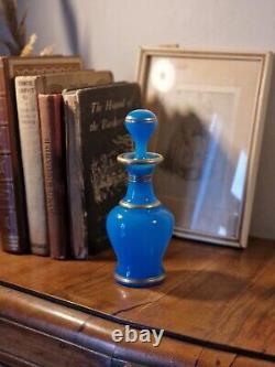 Bouteille de parfum en verre opalin bleu français antique de style victorien avec motifs de bordure dorée.